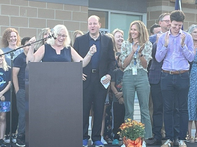 Aspen Creek K-8 teacher Sara Sloan celebrates as Gov. Polis announces additional funding for the DonorsChoose project. 