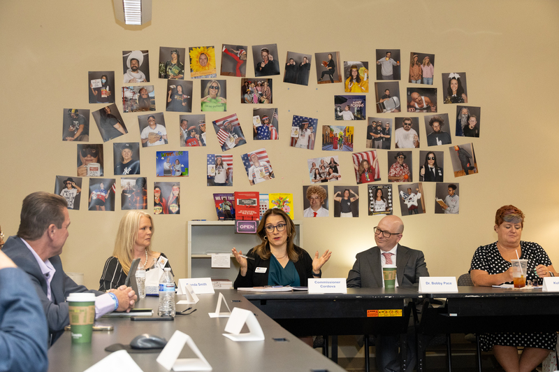 Commissioner of Education Susana Cordova speaks while seated at a table with Cherry Creek School District officials. 