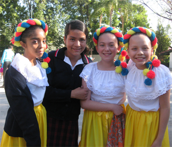 Four students standing and smiling 