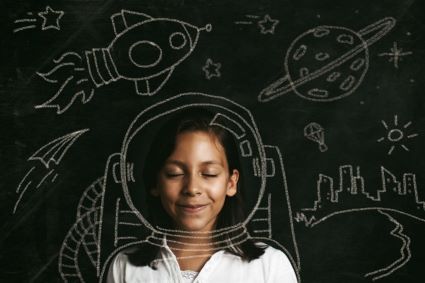 student in front of chalk board thinking of space