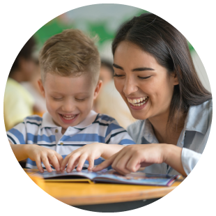 Photo of teacher with child who is reading