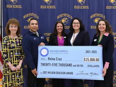 Reina Cruz holding a check for $25,000 after winning the Milken Educators award. 