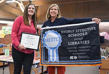 Suzi Tonini, School Library Leadership Consultant, presenting award to Weld RE-4 HESTL recipient