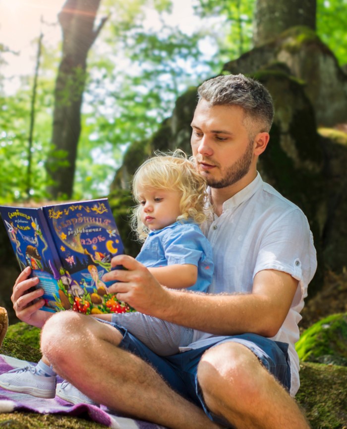 Parent reading to child in nature