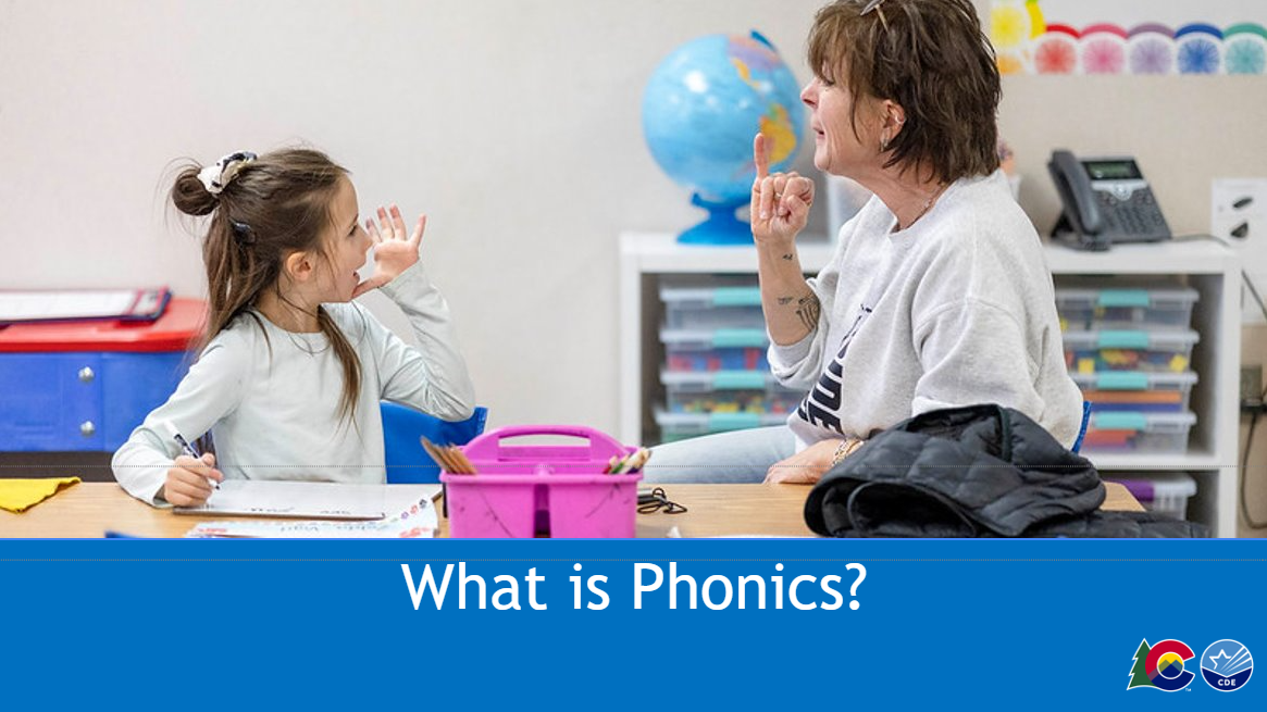 Image of teacher working with a student at small group table