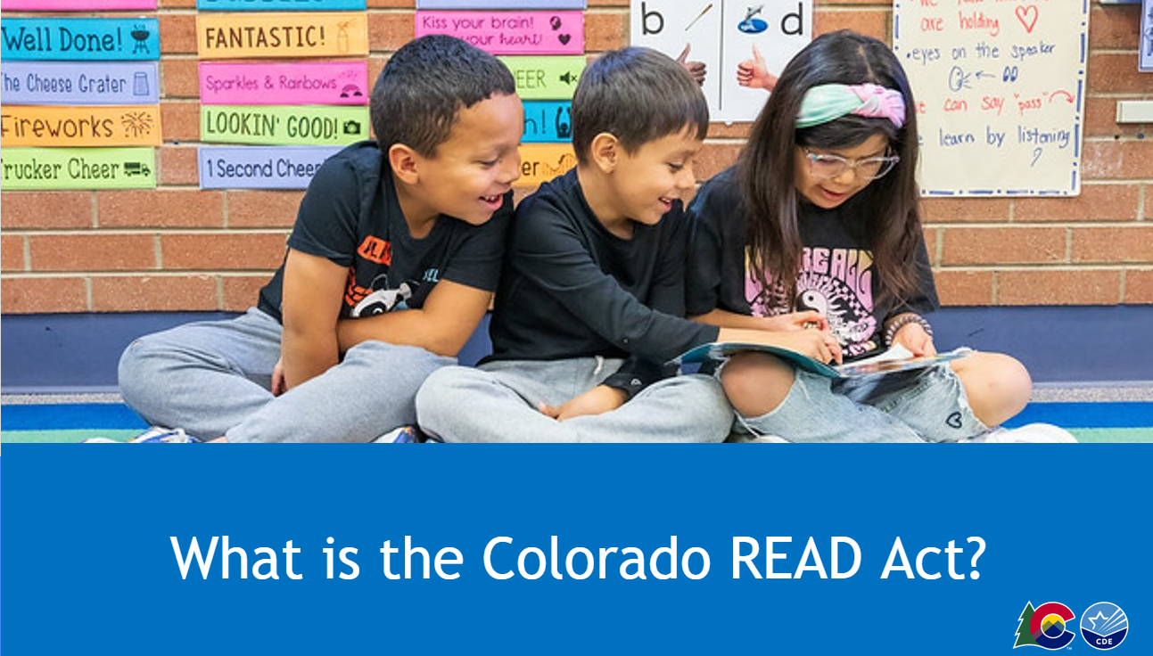 Image of three students reading a book