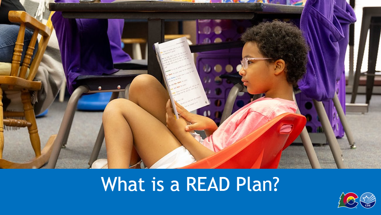 Child sitting in a reclining chair reading a book