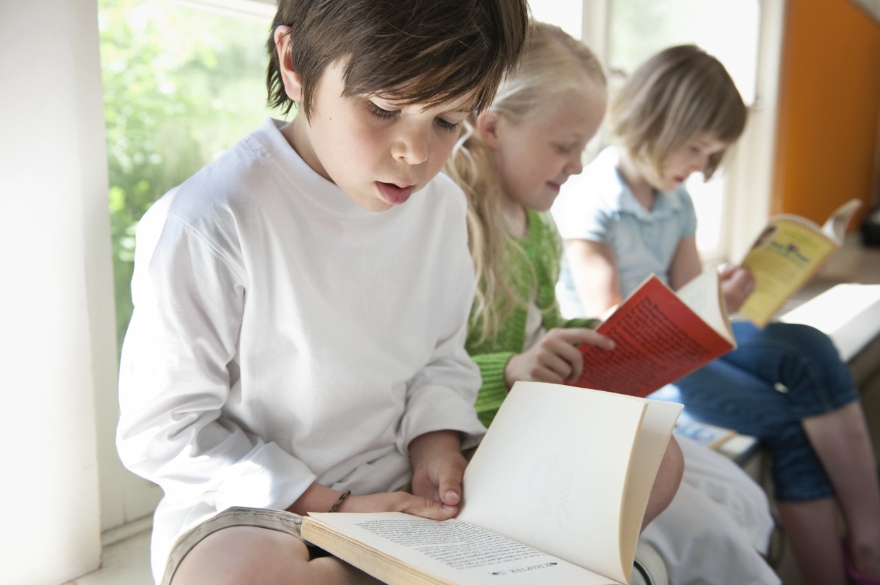 Photo of a child reading. 