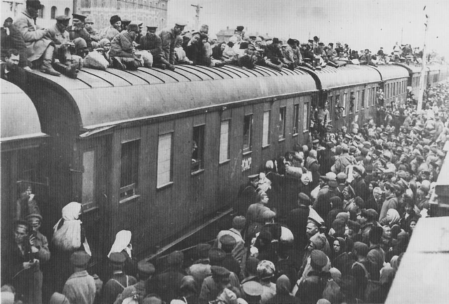 Refugees try to escape the Ukraine flood by hopping onto a train. Some cling to the roof to get out. Ukraine, USSR. 1933.