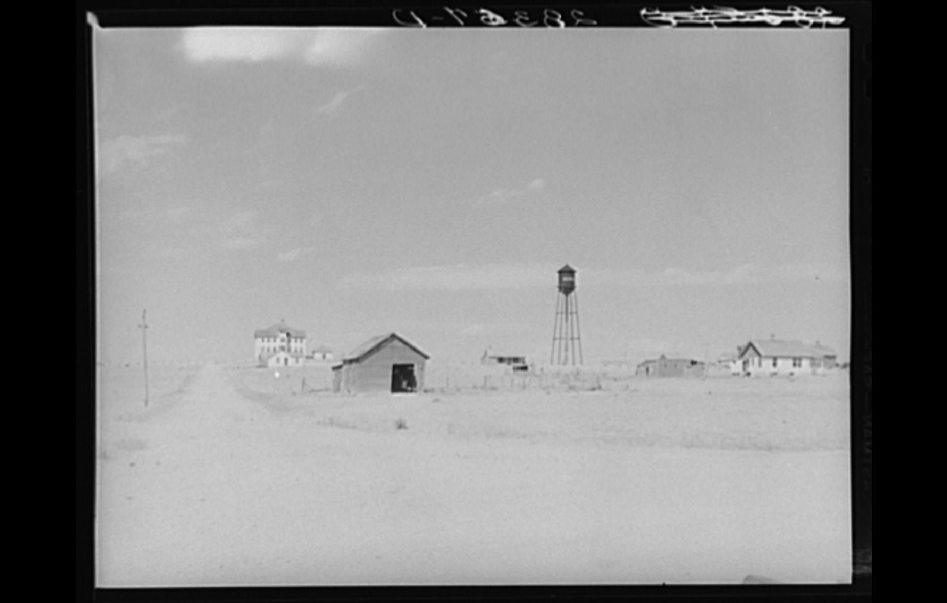 Photograph the the Keota school and water tower.