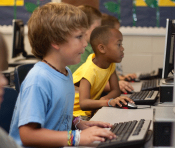 Kids using the computer in school. 